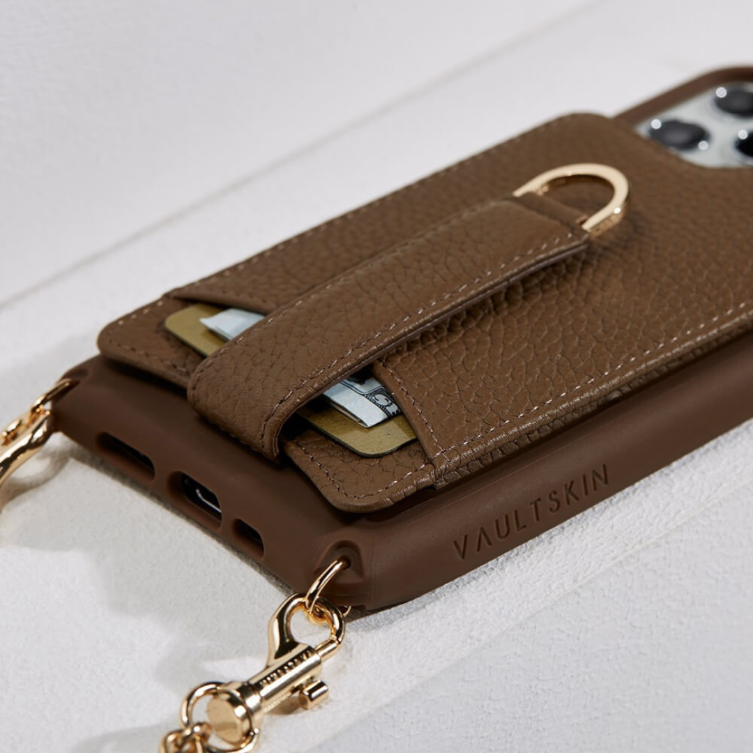 VICTORIA wallet case in brown leather with gold clasps, card slot and cash tucked inside, attached to a phone