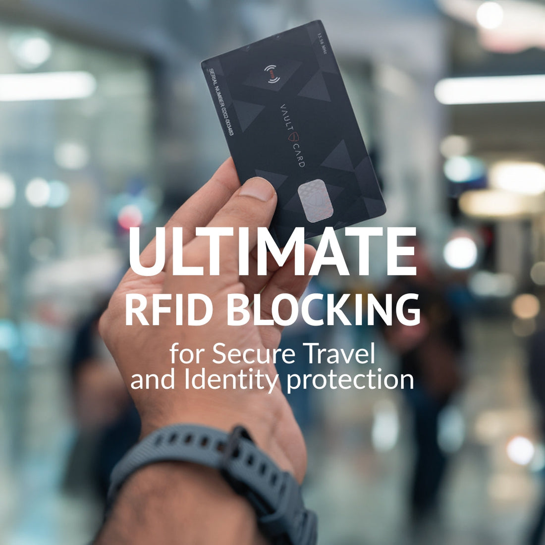 A hand holds up a black RFID-blocking card in a busy shopping mall