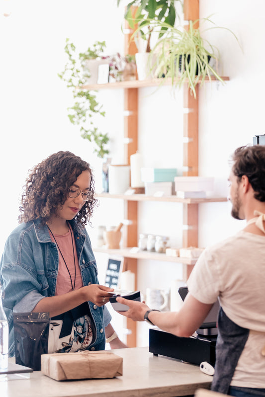 Woman paying with her credit card at a shop check-out