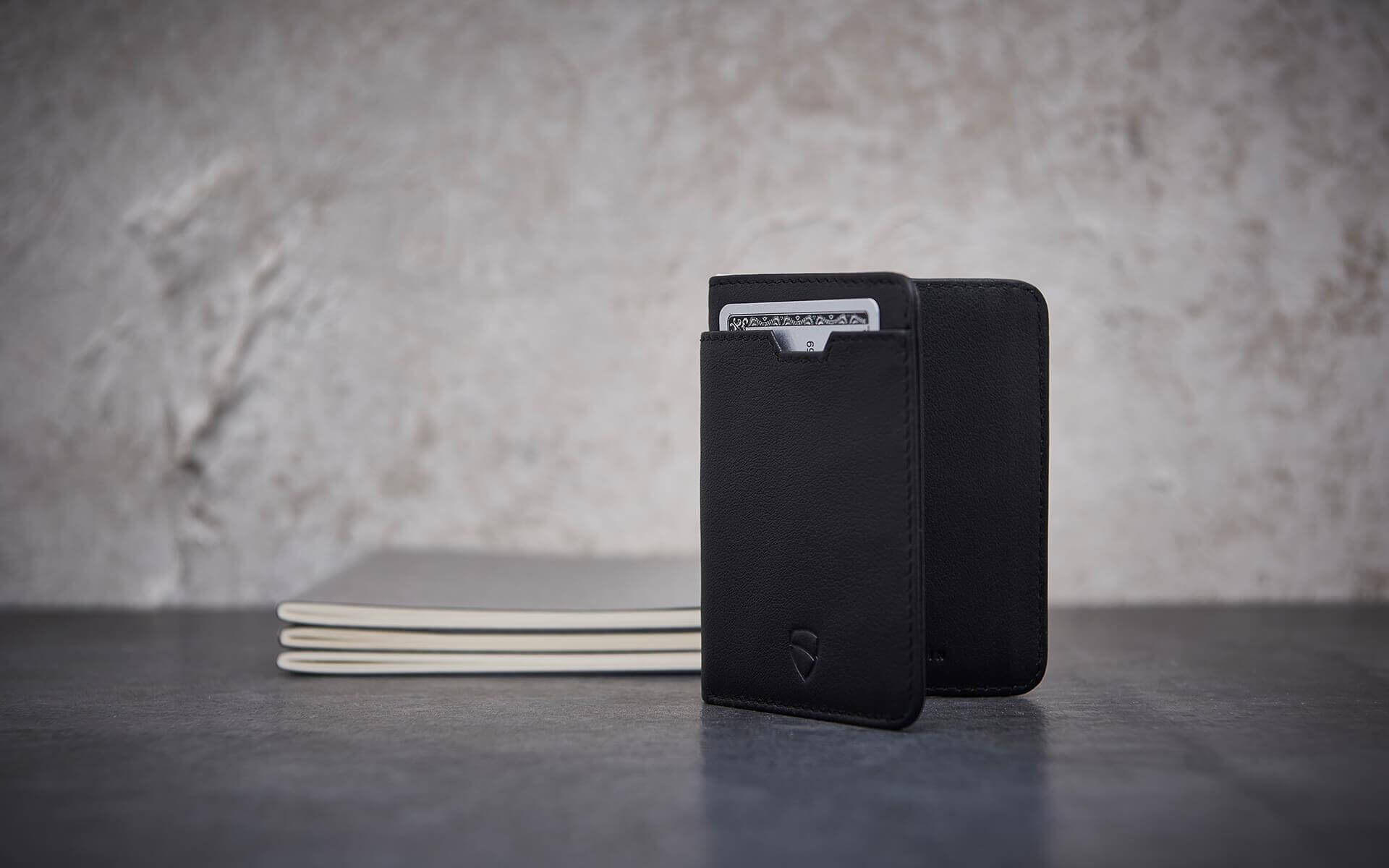 Functional demonstration of Vaultskin CITY's RFID protection feature, with a focus on its compact design and efficient space usage for cards and cash