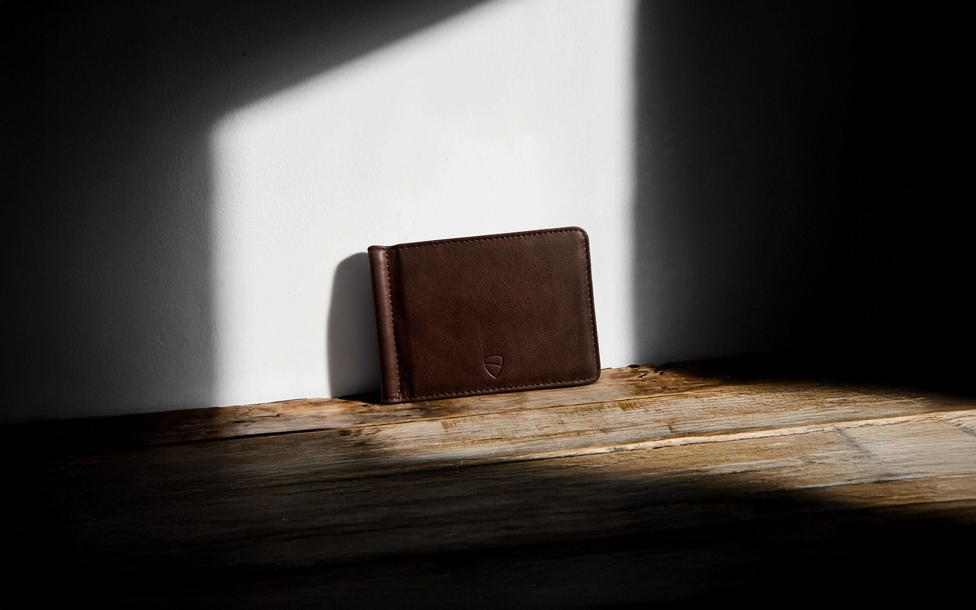 Vaultskin BROMPTON brown leather wallet under artistic light and shadow, minimalist RFID blocking wallet for everyday carry