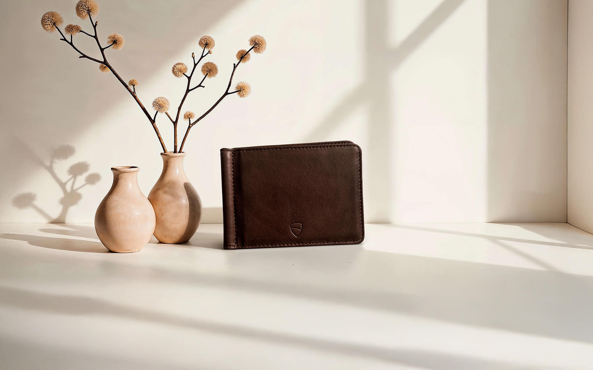 Vaultskin BROMPTON brown leather wallet on white surface with vases, stylish slim leather card holder with RFID protection