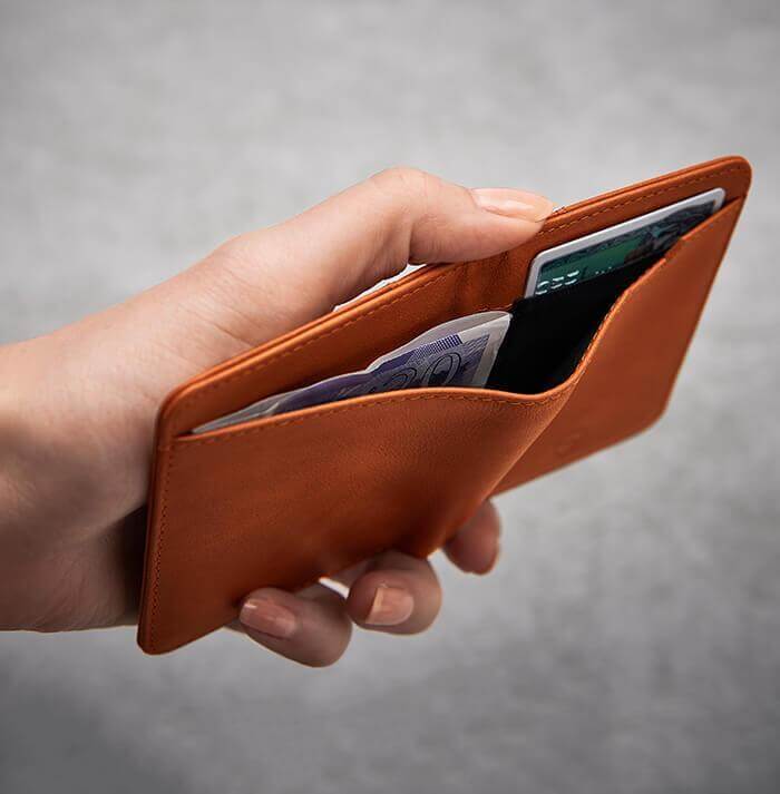 Vaultskin CITY's slim cognac wallet, offering RFID shielding encased in luxurious, durable Italian leather for the discerning individual