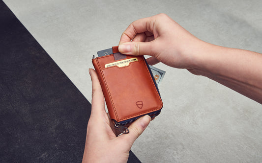 Two hands holding a zipper wallet