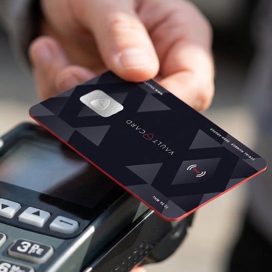 A VAULTCARD held above a contactless card terminal, the jamming card that blocks reads of RFID cards at close range