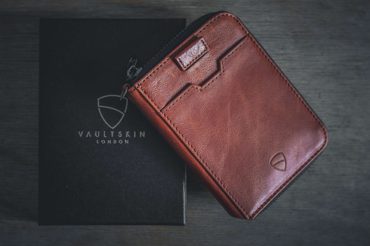 Vaultskin brown leather zip wallet on a black Vaultskin London gift box