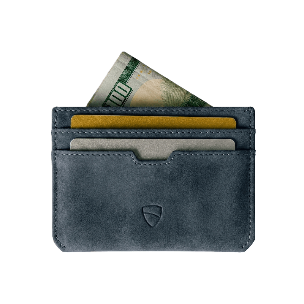 Vaultskin Moorgate midnight teal slim leather wallet overhead flat lay with cards and cash, white background